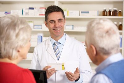 pharmacist with senior couple in pharmacy